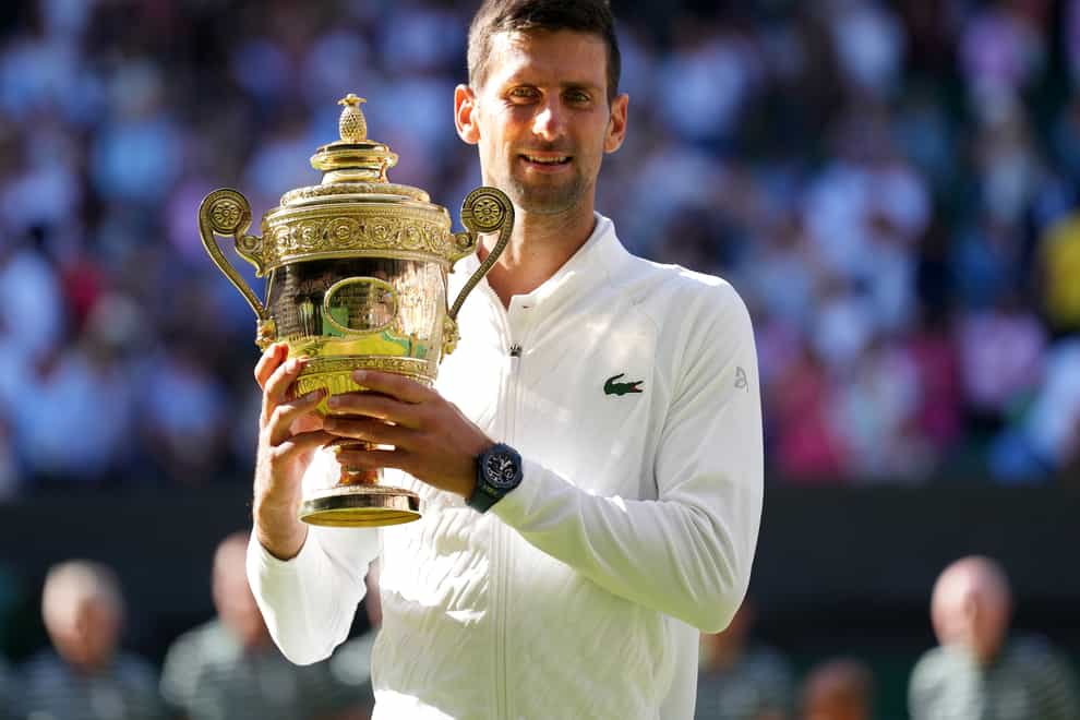 Novak Djokovic holds the Wimbledon trophy for the seventh time (Zac Goodwin/PA)