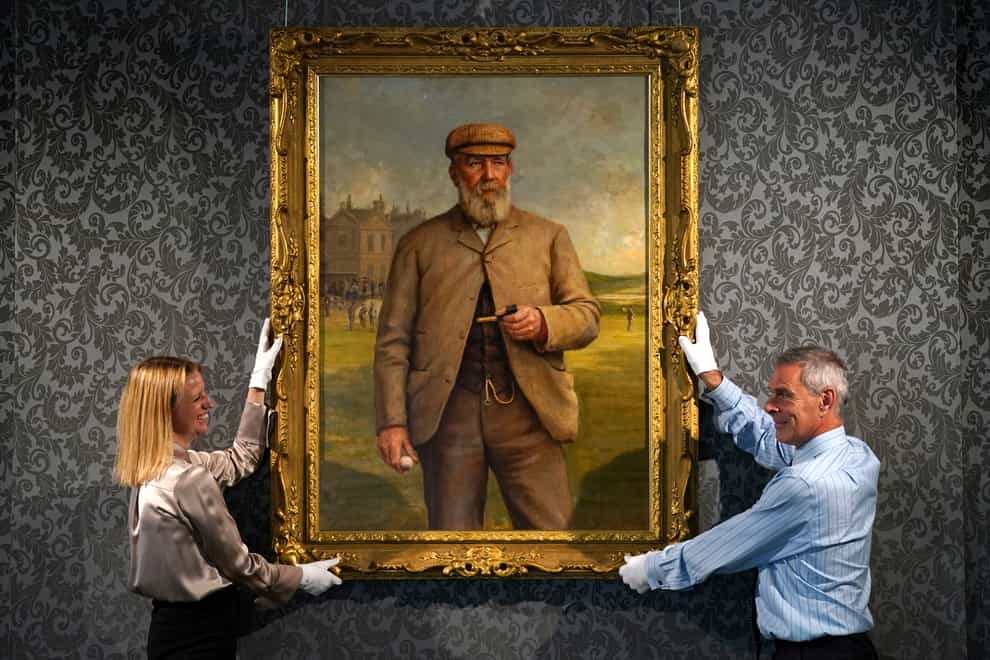 May Matthews and Charles Graham-Campbell from Bonhams with a ‘Portrait of Tom Morris Senior’ by Henry Brooks (Andrew Milligan/PA)