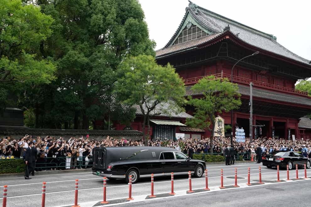 The vehicle carrying the body of former Japanese prime minister Shinzo Abe leaves Zojoji temple after his funeral in Tokyo on Tuesday July 12 2022 (Hiro Komae/AP)