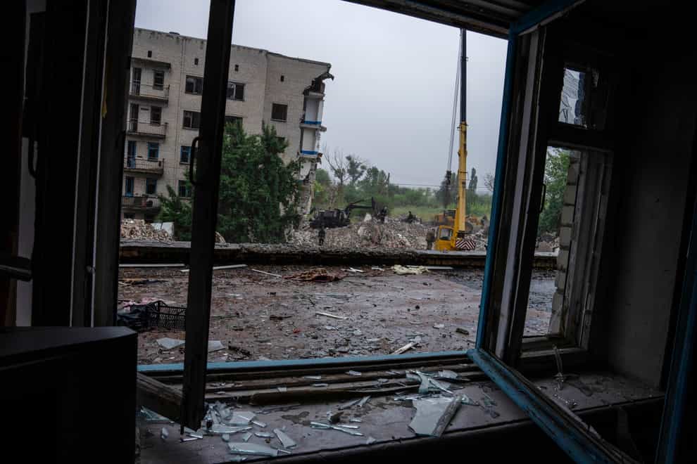 Ukrainian emergency personnel work to pull people out of the rubble after a Russian rocket attack smashed into apartment buildings, in Chasiv Yar, Donetsk region, eastern Ukraine (Nariman El-Mofty/AP)