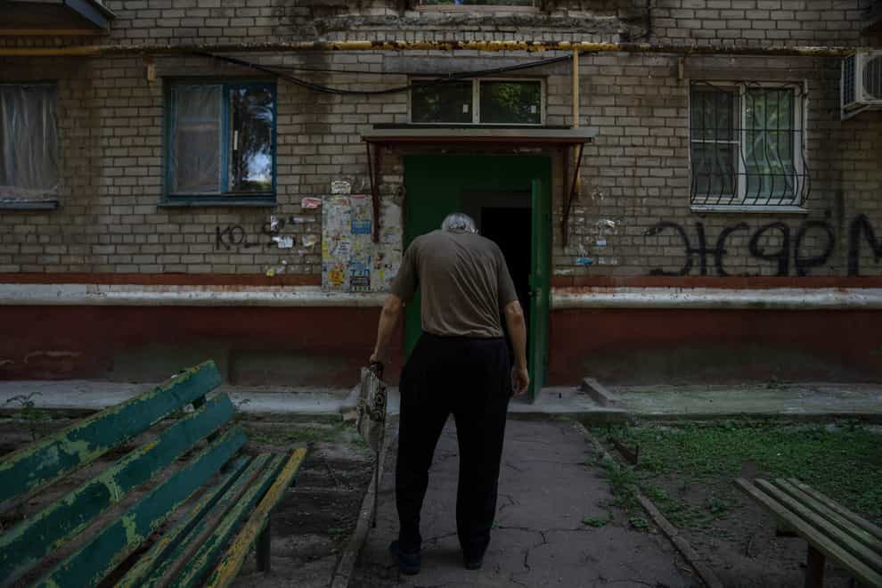 Seventy-year-old pensioner Valerii Ilchenko, who lives alone and is refusing to evacuate, walks to his apartment, after filling out his daily crossword, in Kramatorsk, eastern Ukraine (Nariman El-Mofty/AP)