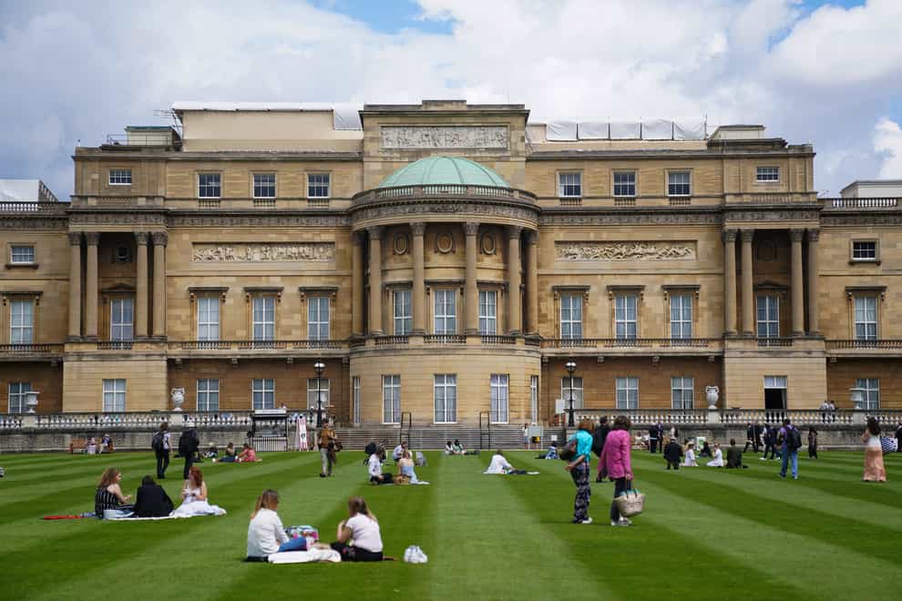 Visitors enjoy picnics on the lawn during a preview of the Garden at Buckingham Palace in 2021 (Kirsty O’Connor/PA)