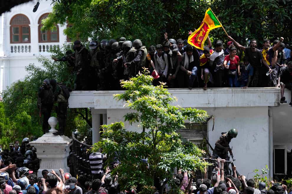 Sri Lankans woke up to confusion on Thursday, still waiting for their president to resign after he fled the country (Eranga Jayawardena/AP)