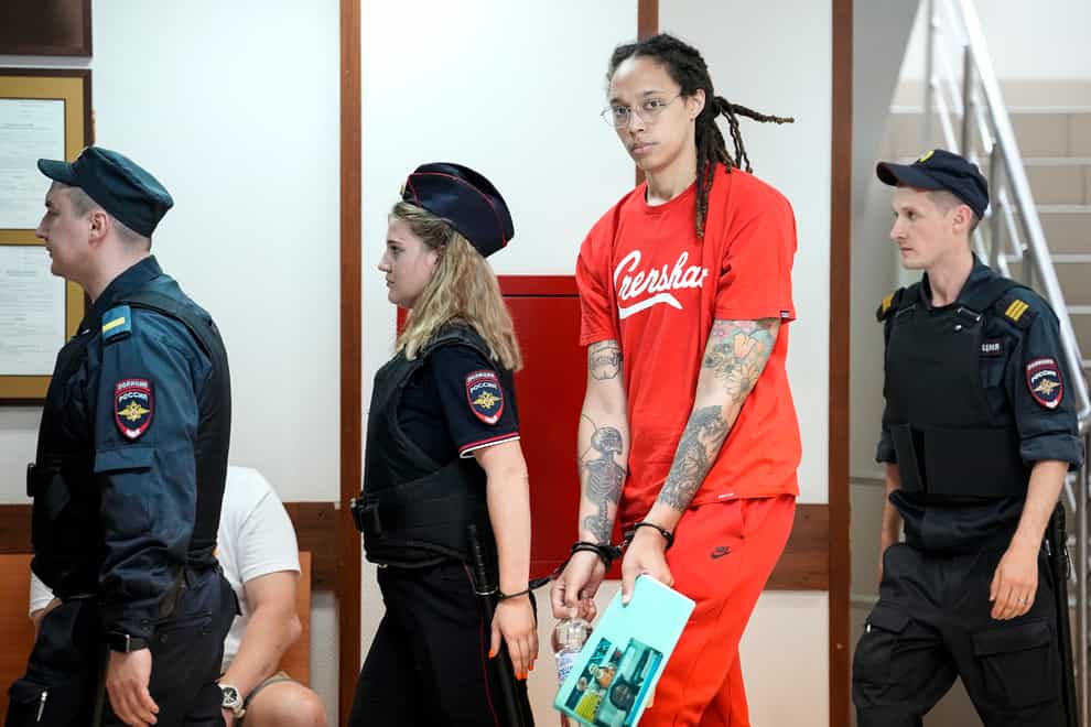 WNBA star and two-time Olympic gold medalist Brittney Griner is escorted to a courtroom for a hearing in Khimki, Russia (Alexander Zemlianichenko/AP)