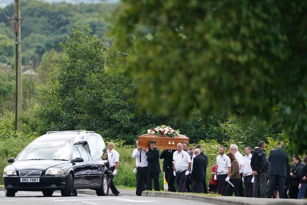 The coffin of John Steele is carried by mourners up Churchill Road following a funeral service at his house in Larne, County Antrim (Brian Lawless/PA)