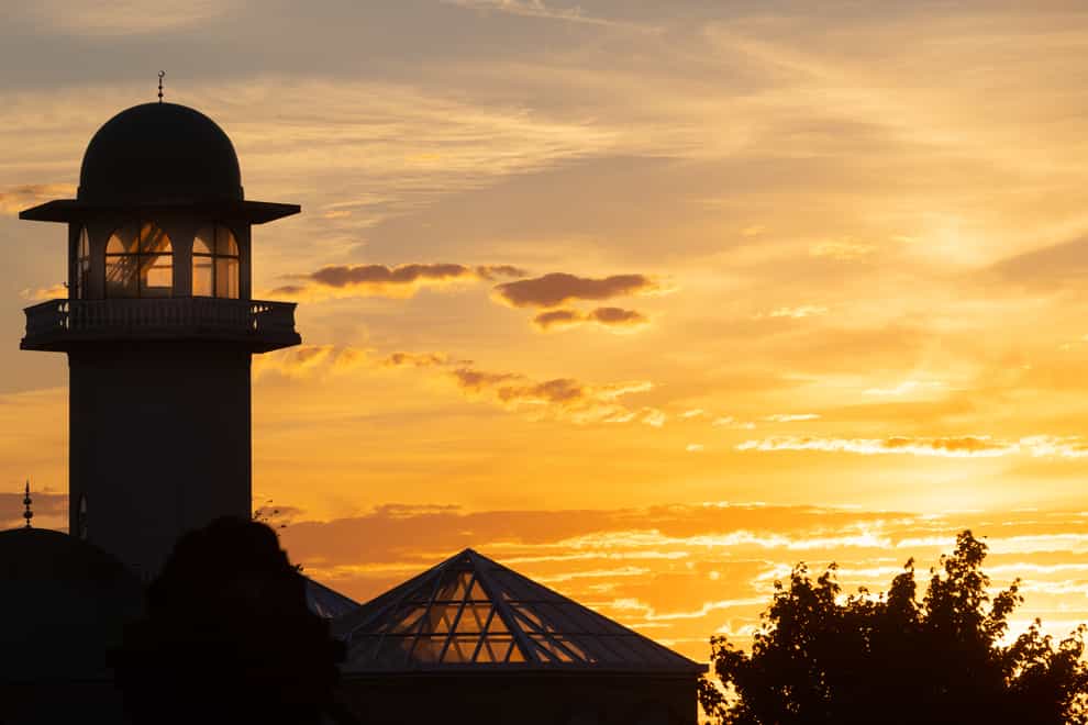 The sun sets over the Central Mosque of Brent, north London. Picture date: Sunday July 10, 2022.