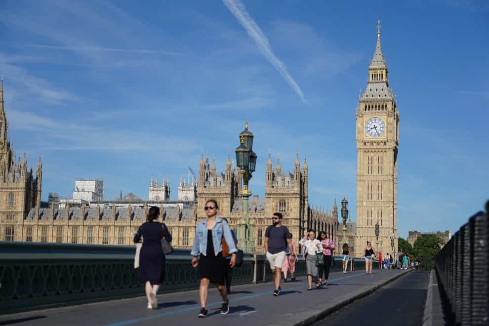 People walk across Westminster Bridge in London amid the heatwave (Dominic Lipinski/ PA)