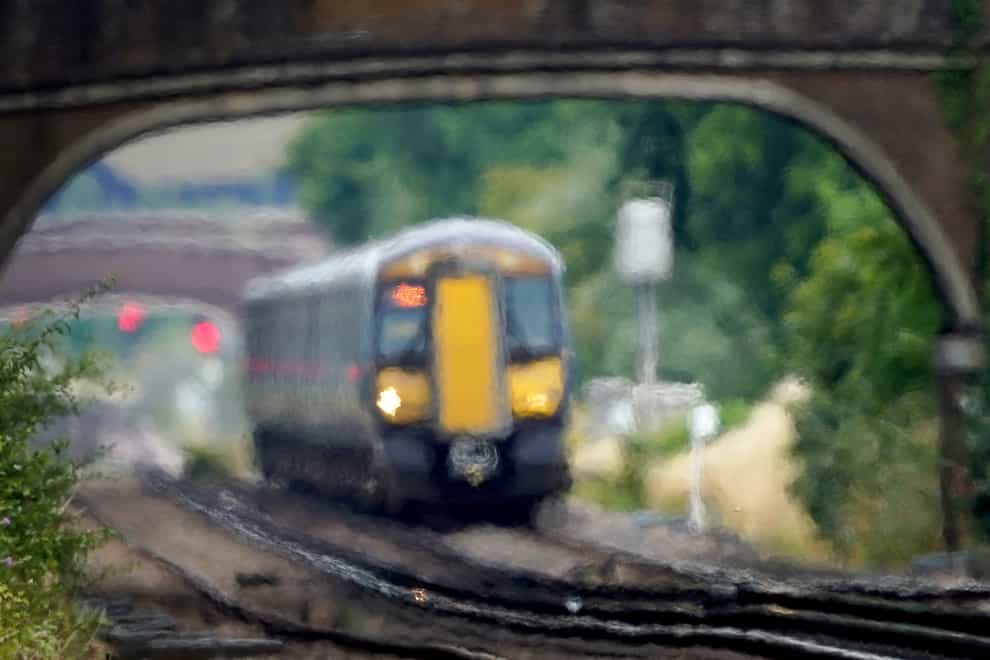 A train passes through heat haze on a railway line near Ashford in Kent (Gareth Fuller/PA)