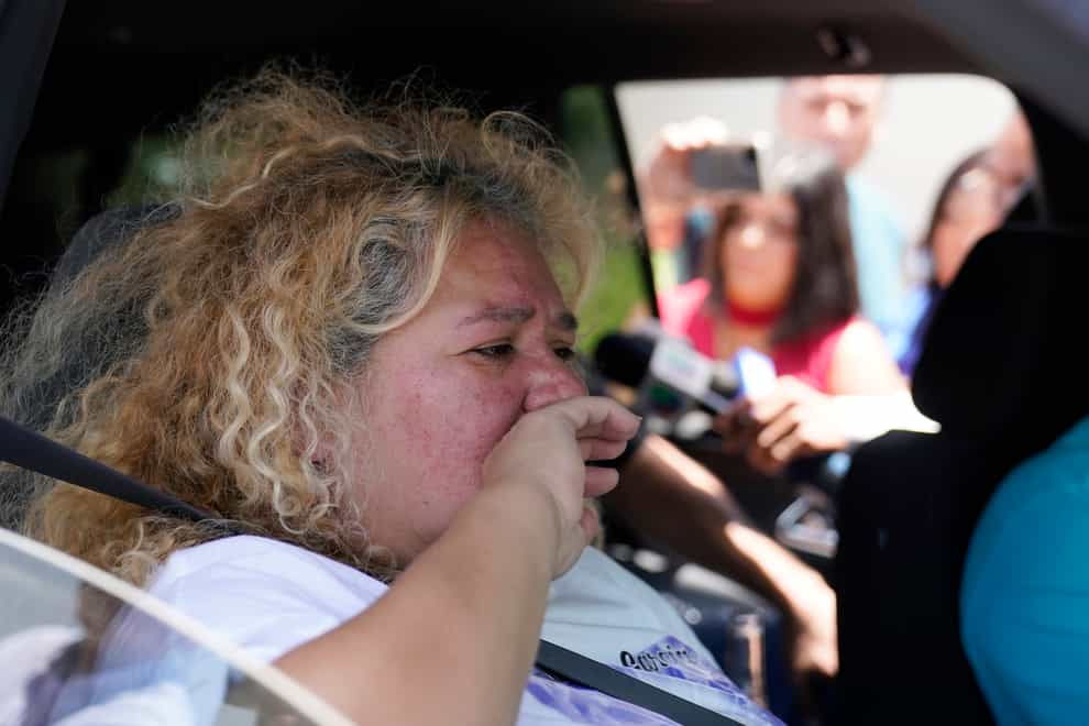 Grace Valencia, great aunt of shooting victim Uziyah Garcia, tries to hold back tears as she talks to the media after picking up a copy of the report (AP)