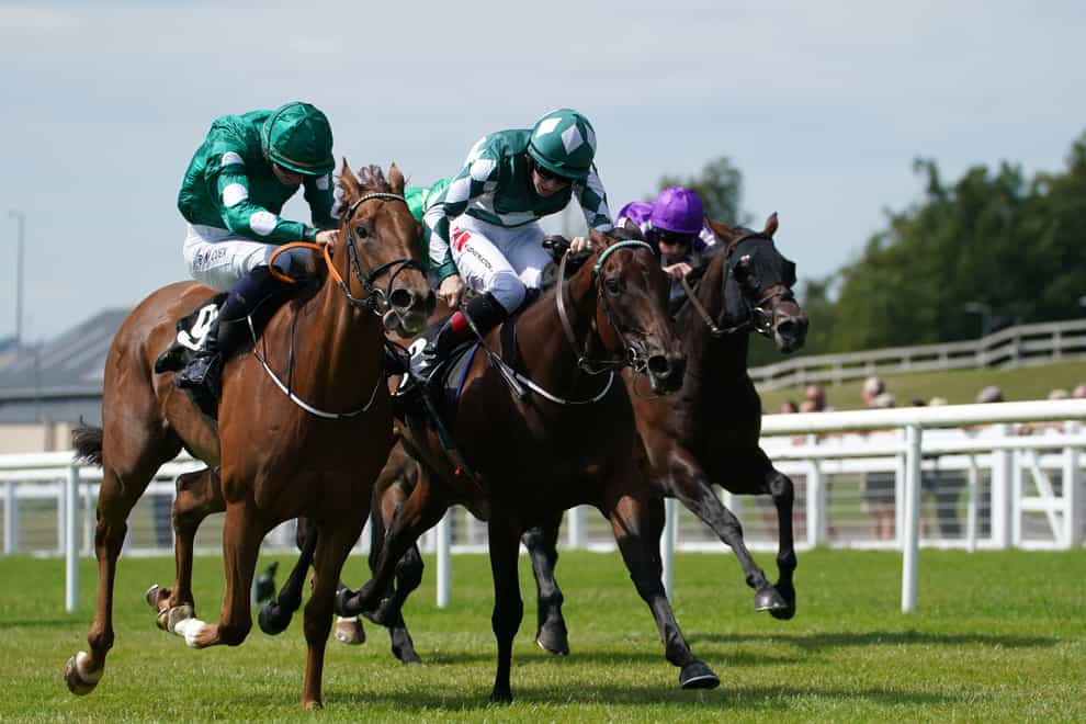 Ladies Church and Mooneista (centre) fight out the finish to the Sapphire Stakes (Brian Lawless/PA)