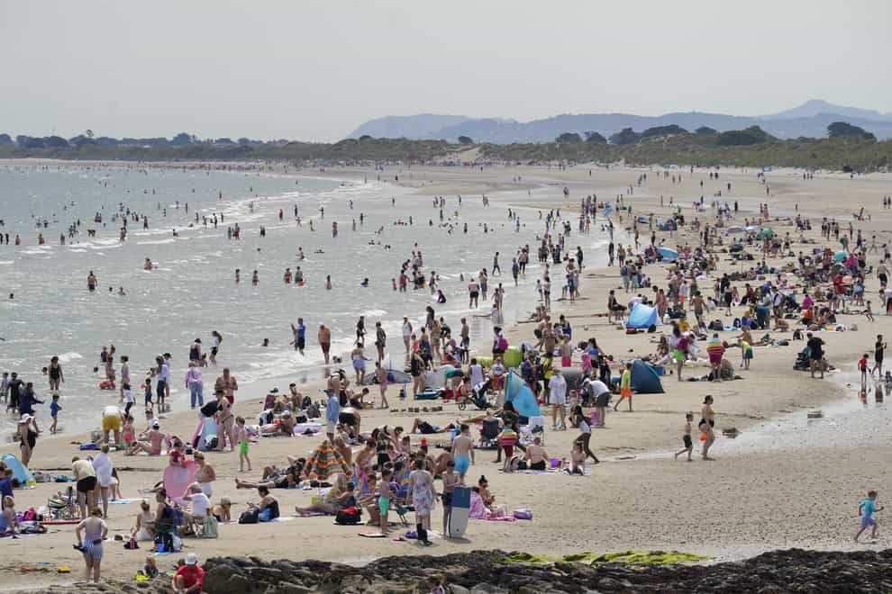 Crowds of people enjoying the sun on Portmarnock beach near Dublin (Niall Carson/PA)