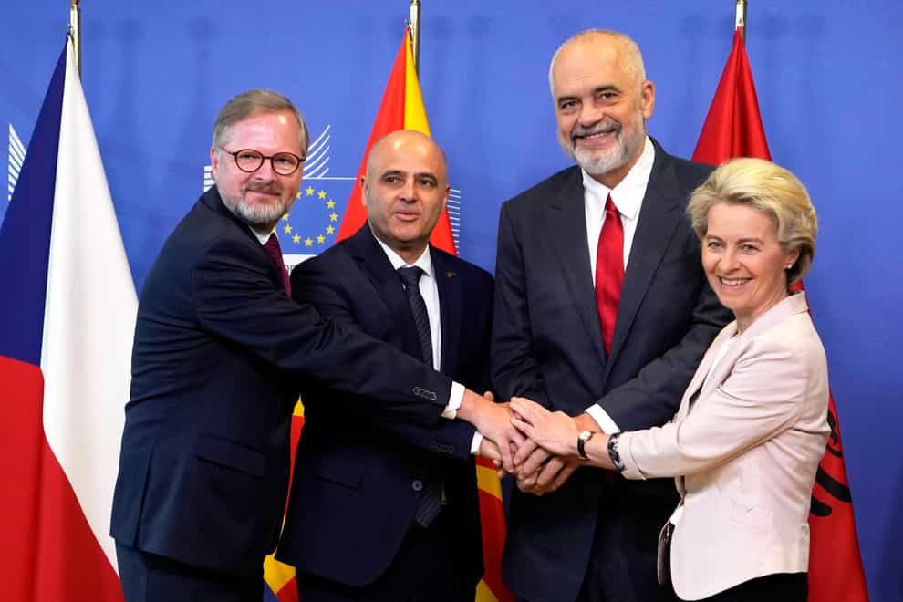 Ursula von der Leyen, Albanian Prime Minister Edi Rama, North Macedonia’s Prime Minister Dimitar Kovacevski and Czech Republic’s Prime Minister Petr Fiala shake hands prior to a meeting at EU headquarters in Brussels, Tuesday, July 19, 2022. The European Union on Tuesday is starting the long enlargement process that aims to lead to the membership of Albania and North Macedonia in the bloc. (AP Photo/Virginia Mayo)