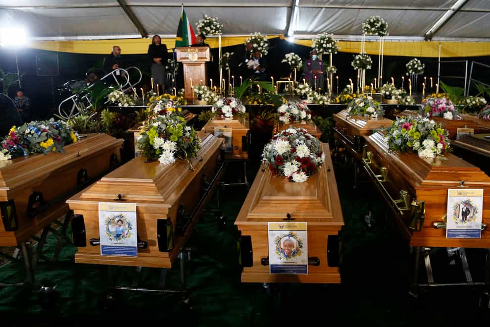 A view of the coffins during a funeral service held in Scenery Park, East London, South Africa, Wednesday, July 6, 2022. More than a thousand grieving family and community members are attending the funeral in South Africa’s East London for 21 teenagers who died in a mysterious tragedy at a nightclub nearly two weeks ago. South African President Cyril Ramaphosa is due to give the eulogy for the young who died. (AP Photo)
