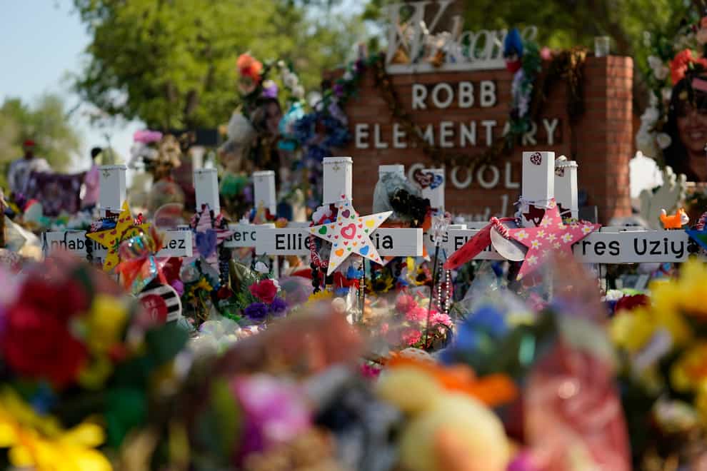 Crosses, flowers and other memorabilia form a make-shift memorial for the victims of the shootings at Robb Elementary school in Uvalde, Texas, Sunday, July 10, 2022. At least $14 million in donations has been raised in private and corporate donations for the families affected by the May 24 shooting, but creating a plan to ensure that the funds are distributed equitably and transparently takes time, usually months (Eric Gay/AP/PA)