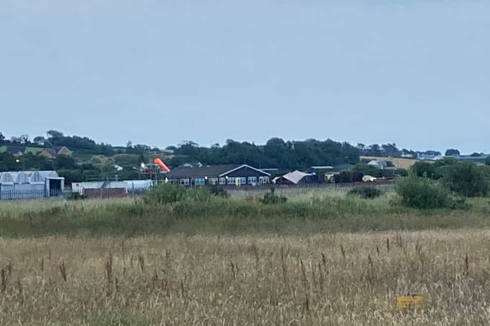Police and emergency services attending Newtownards Airport in County Down, following a crash involving an aircraft. Picture date: Tuesday July 19, 2022.