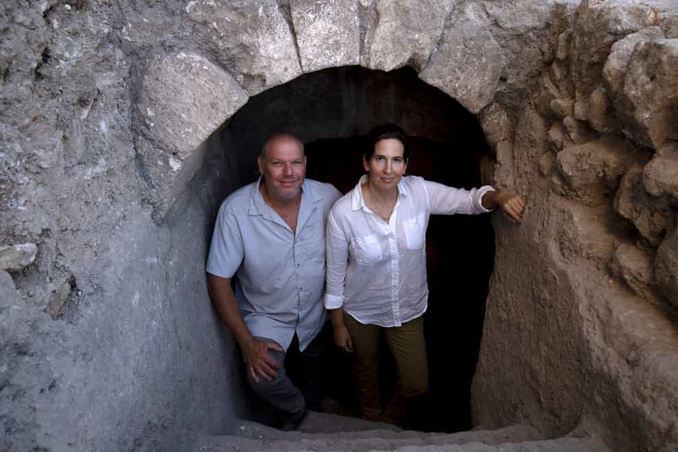 Hebrew University archaeologists Dr Oren Gutfeld, left, and Michal Haber, pose at the site of a Jewish ritual bath near the Western Wall in the Old City of Jerusalem (Maya Alleruzzo/AP)