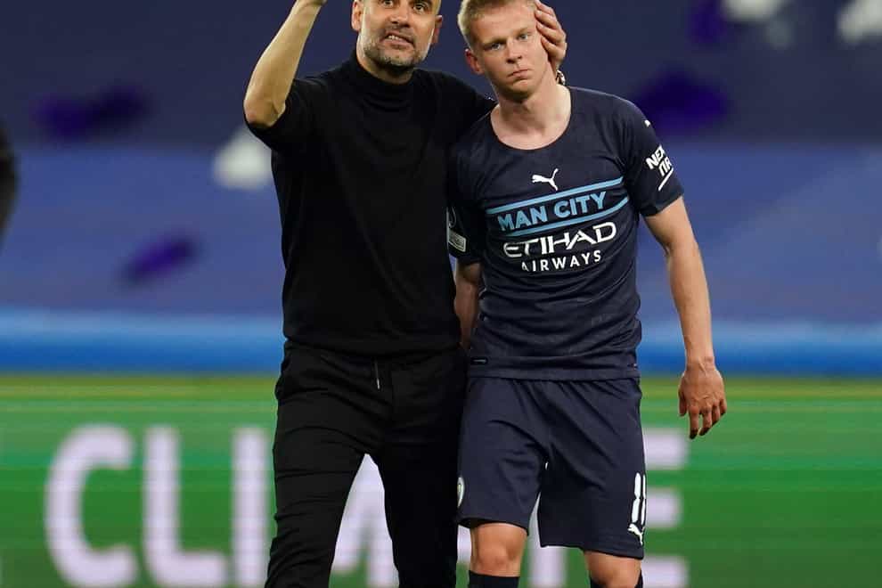 Manchester City manager Pep Guardiola, left, has praised the attitude of Oleksandr Zinchenko ahead of his move to Arsenal (Nick Potts/PA)