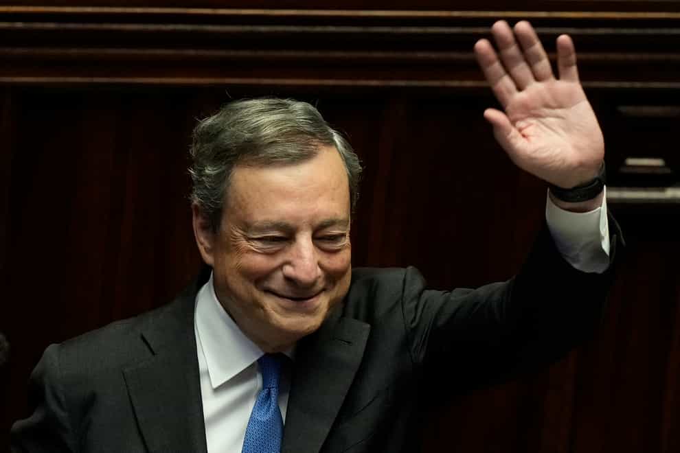 Italian premier Mario Draghi waves to politicians at the end of an address at the Parliament in Rome (Andrew Medichini/AP)