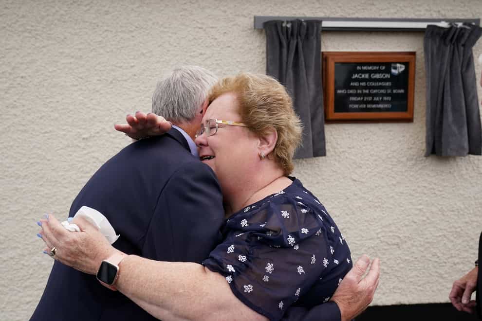 Daughter of bus driver Jackie Gibson Lynda Van Cuylenburg hugs her brother Robert Gibson, at an event with some of their father’s former colleagues in Ulsterbus and current drivers to unveil a plaque at the depot in Ballygowan where he began his journey on Bloody Friday. Jackie was killed in the bomb that detonated at the Oxford Street bus station on July 21 1972. Picture date: Thursday July 21, 2022.