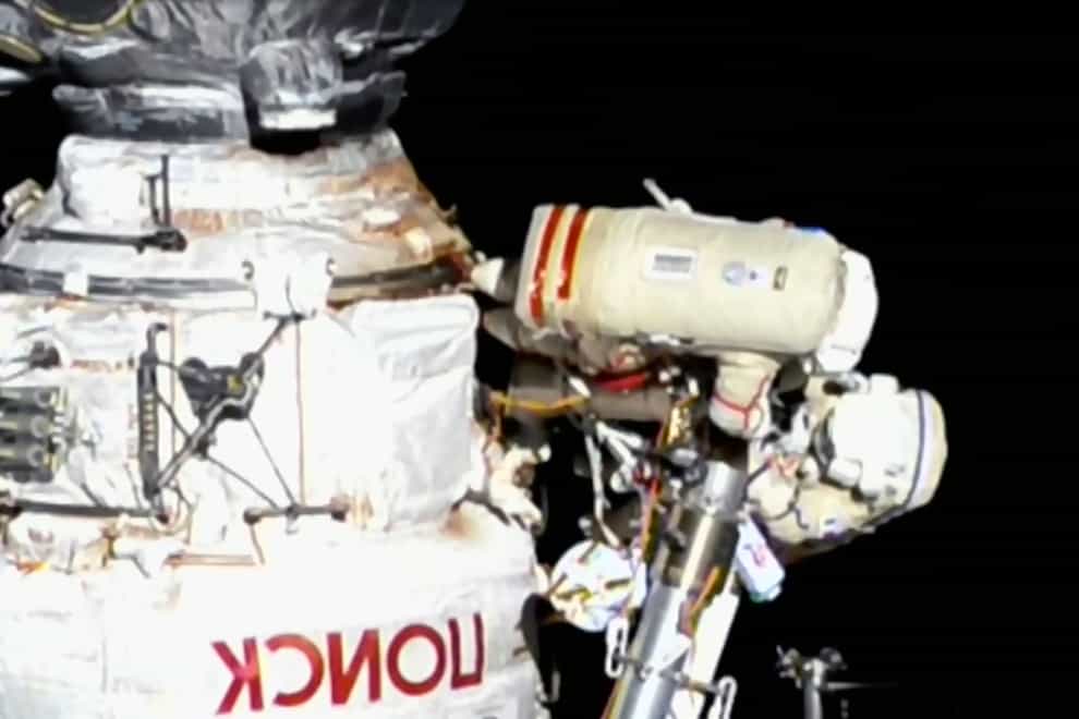 Italian astronaut Samantha Cristoforetti and Russian cosmonaut Oleg Artemyev perform maintenance on the International Space Station (Nasa/AP)