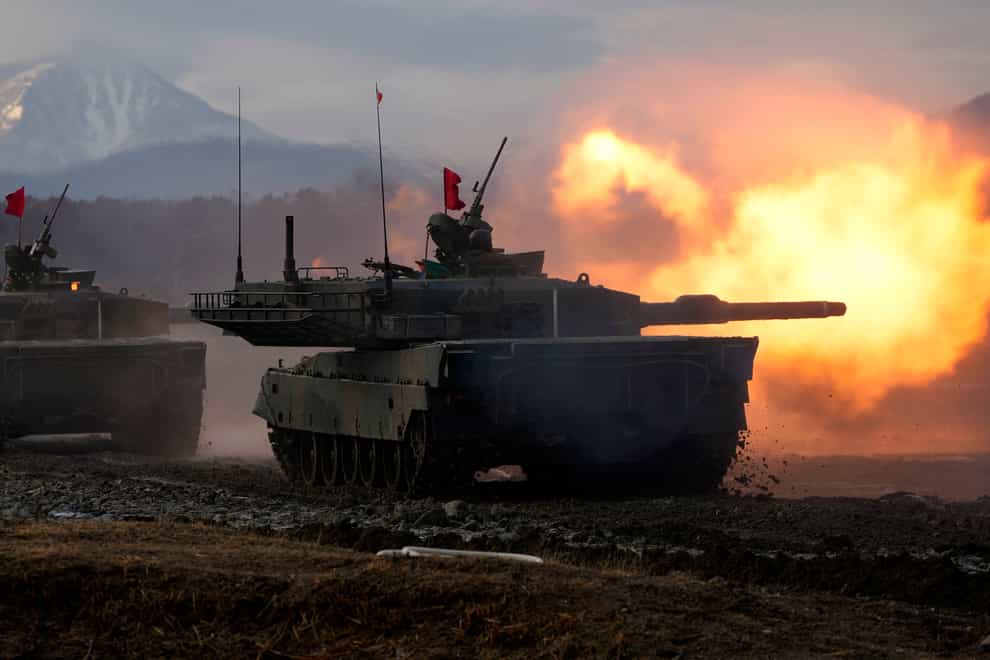 A Japanese Ground-Self Defence Force (JGDDF) Type 90 tank fires its gun at a target during an annual drill exercise as Japan tries to bolster its military capability and spending (Eugene Hoshiko/AP/PA)