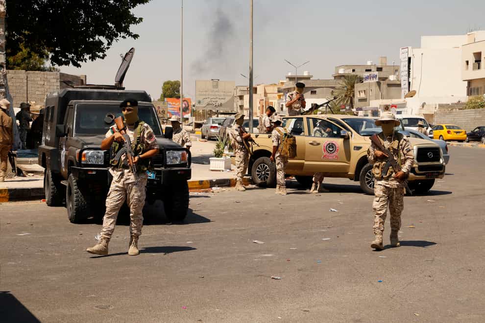 Libyan army forces and vehicles are stationed in a street in the country’s capital of Tripoli. One of Libya’s rival governments on Friday called on militias to stop fighting, after clashes broke out in the country’s capital, Tripoli overnight, killing at least one civilian and forcing around 200 people to flee the area.(Yousef Murad/AP/PA)