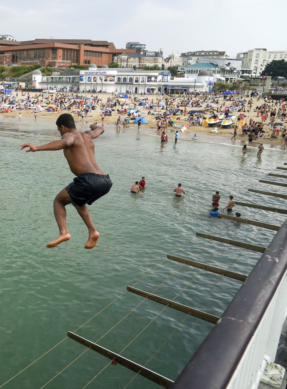 A man jumps from the pier in Bournemouth (PA)
