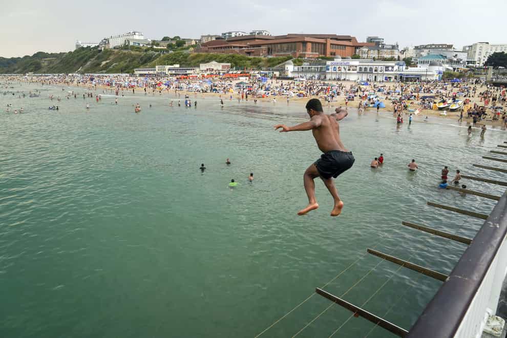A man jumps from the pier in Bournemouth (PA)