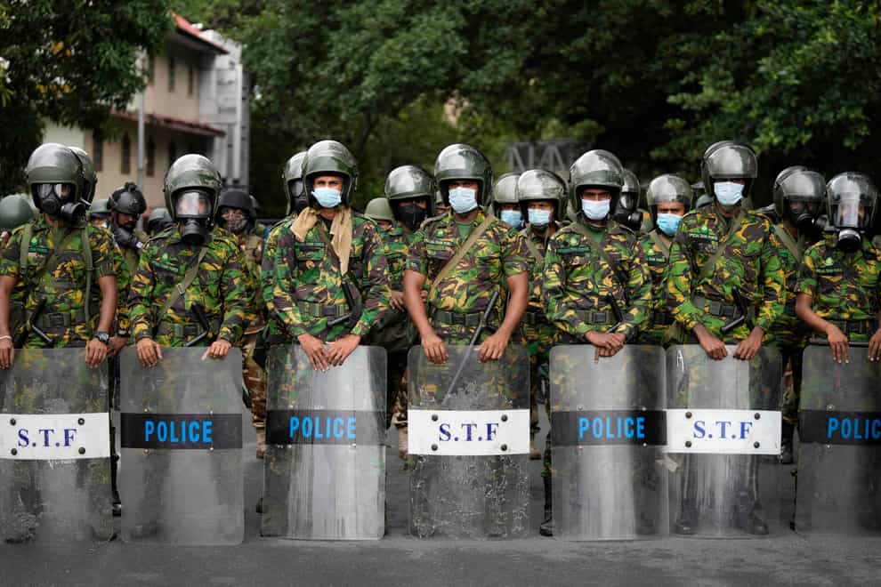 Police commandos stand guard at a barricade outside the president’s office in Colombo, Sri Lanka (Eranga Jayawardena/AP)