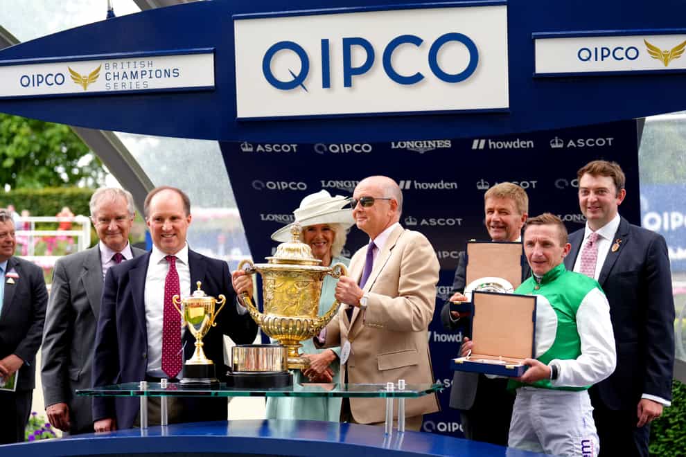 William Muir (third right), Chris Grassick (right), jockey PJ McDonald and co-owner Roger Pyle (holding the trophy) celebrate Pyledriver’s success (John Walton/PA)