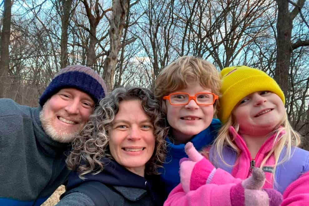 Tyler Schmidt, left, and his wife Sarah pose with their son Arlo and daughter Lula, right, while hiking near Cedar Falls, Iowa (Schmidt and Morehead families)