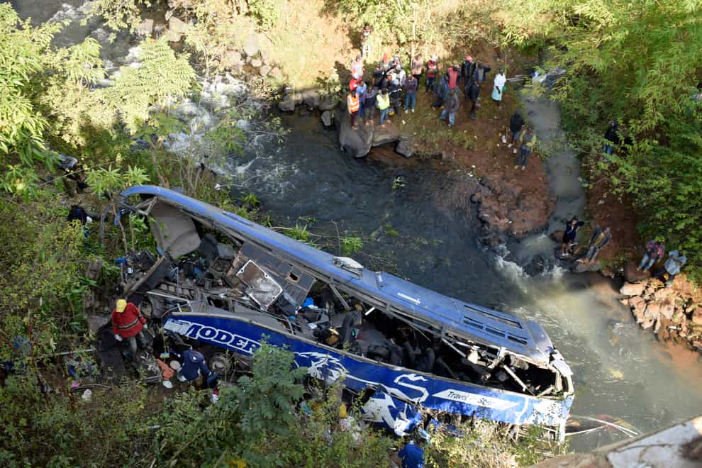 A view of the wreckage of a bus that plunged into Nithi bridge on Sunday, in Tharaka Nithi county Meru, Kenya, Monday, July 25, 2022. Police in Kenya say 30 people have died after a bus fell off a bridge and plunged into a river along the highway from the capital, Nairobi (Dennis Dibondo/AP/PA)
