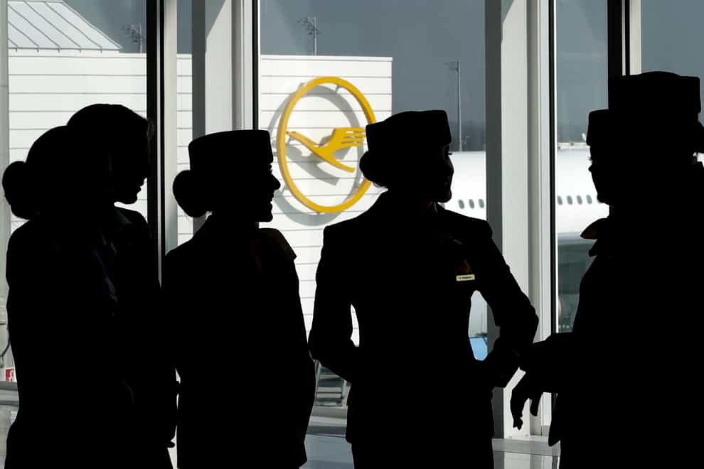 Lufthansa flight attendants silhouetted as they pose for a photograph on occasion of the company’s annual press conference in Munich, Germany. A German union has called on Lufthansa ground staff to walk out on a one-day strike Wednesday in a dispute over pay (Matthias Schrader/AP/PA)