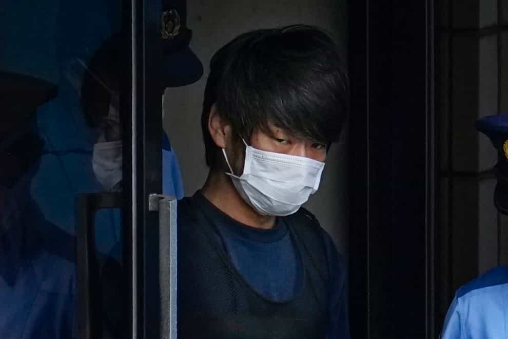 Tetsuya Yamagami, the alleged assassin of Japan’s former Prime Minister Shinzo Abe, gets out of a police station in Nara, western Japan, on July 10, 2022, on his way to local prosecutors’ office. The suspect will be detained until late November for mental evaluation so prosecutors can determine whether to formally press charges and sent him to trial for murder (Nobuki Ito/Kyodo News via AP/PA)