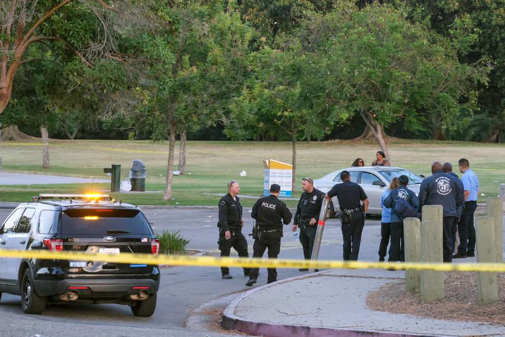 Police officers stand near the scene of a shooting at Peck Park in San Pedro, California, Sunday, July 24, 2022 (Ringo HW Chiu/AP/PA)