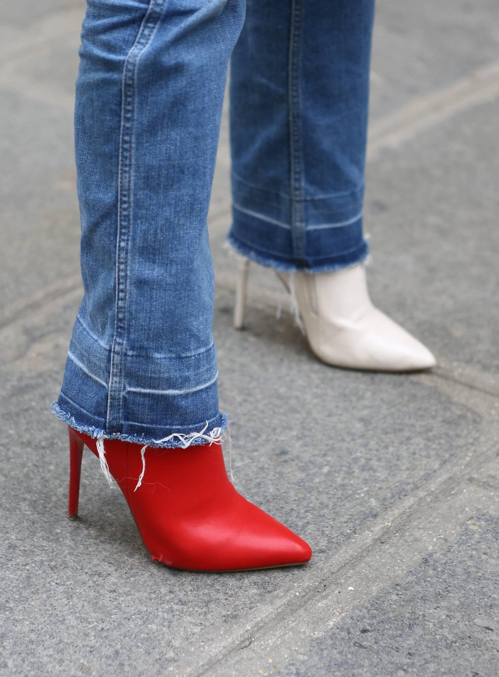 A fashionista wearing mismatched Celine boots during Paris Fashion Week (Alamy/PA)
