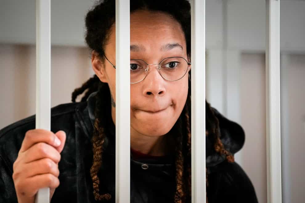 Brittney Griner speaks to her lawyers standing in a cage at a courtroom prior to a hearing in Khimki, just outside Moscow, Russia (Alexander Zemlianichenko, Pool/AP)