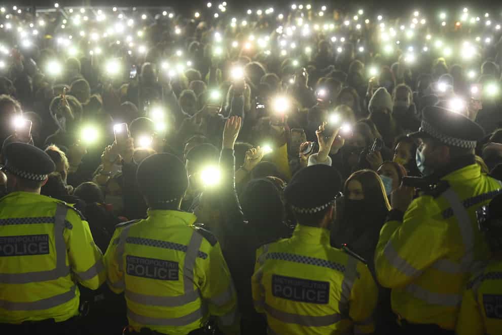 People in the crowd turn on their phone torches in Clapham Common during the vigil. (PA)
