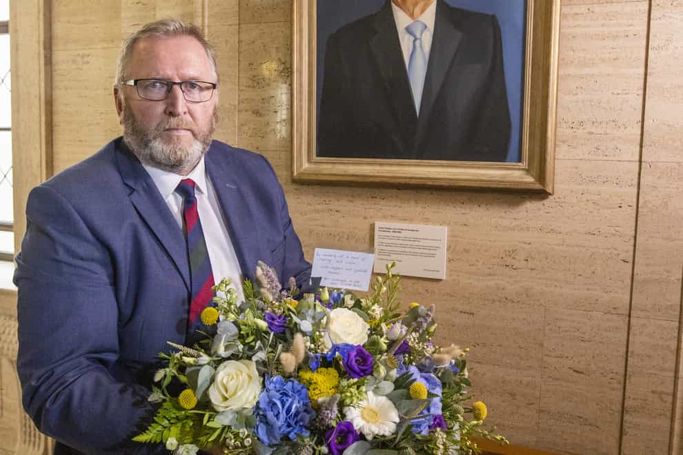 Doug Beattie, leader of the Ulster Unionist Party (UUP) lays a wreath under the portrait of the party’s former leader David Trimble, in the Great Hall of Parliament Buildings at Stormont (Liam McBurney/PA)