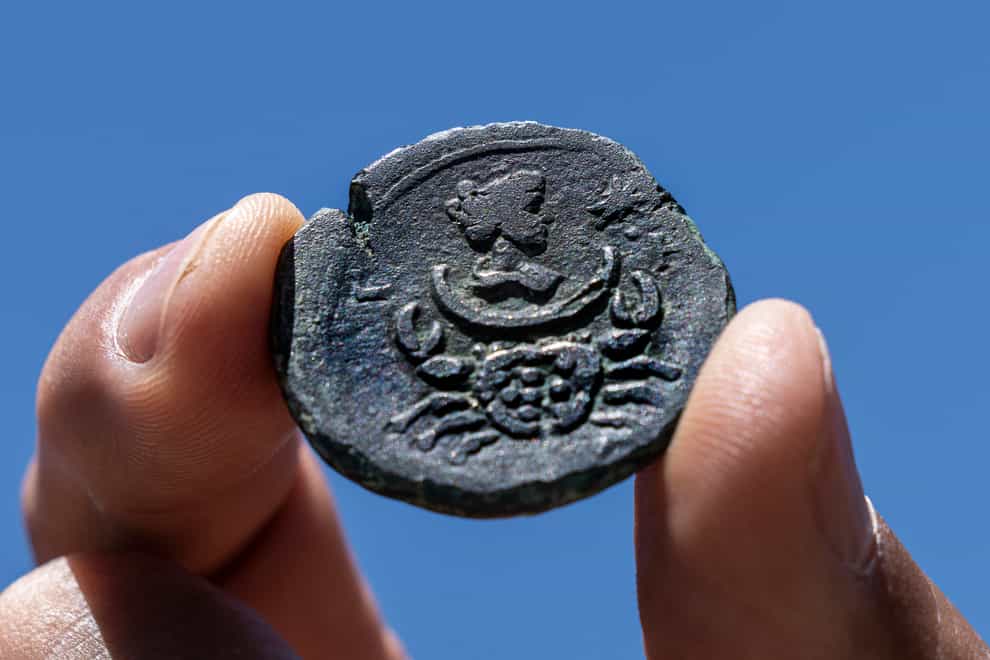 A rare, nearly 1,850-year-old bronze coin discovered off the Israeli coastal city of Haifa is on display at Israel’s Antiquities Authority office in Jerusalem (Tsafrir Abayov/AP)