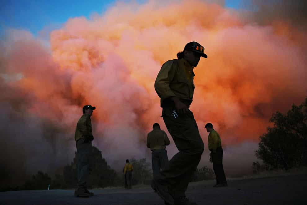 Firefighters have made more progress against a huge California forest fire that forced evacuations for thousands of people and destroyed 41 homes and other buildings near Yosemite National Park (Eric Paul Zamora/The Fresno Bee via AP)