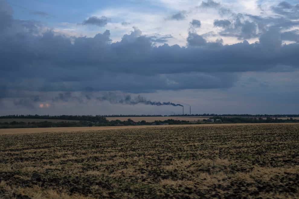 Grain fields backdropped by a power plant in Donetsk region, eastern Ukraine (Nariman El-Mofty/AP)