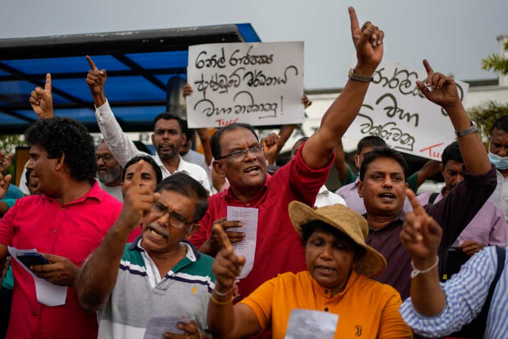 Members of the People’s Liberation Front shout anti government slogans during a protest denouncing corruption and demanding a fresh parliamentary election in Colombo, Sri Lanka (Eranga Jayawardena/AP)
