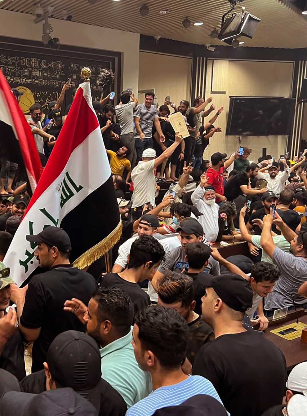 Iraqi protesters breach the parliament in Baghdad (Ali Abdul Hassan/AP)