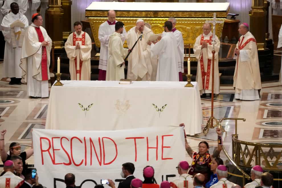 A banner displayed during Mass at the National Shrine of Sainte-Anne-de-Beaupre in Quebec City, Canada (Gregorio Borgia/AP)