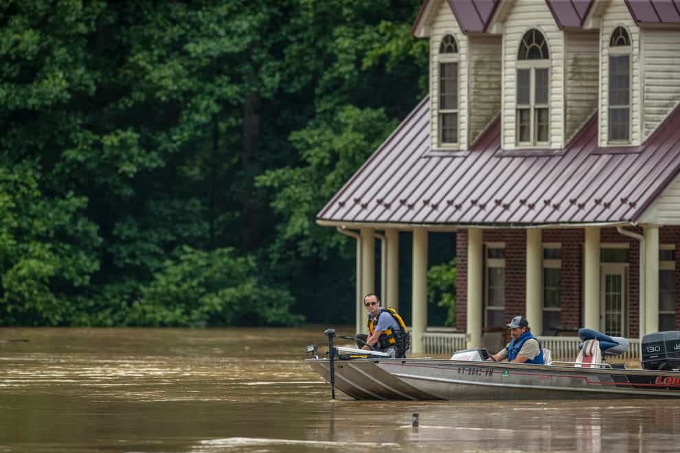 Torrential rains have unleashed devastating floods in Appalachia as fast-rising water killed at least eight people in Kentucky and sent people scurrying to rooftops to be rescued (Ryan C Hermens/Lexington Herald-Leader via AP)