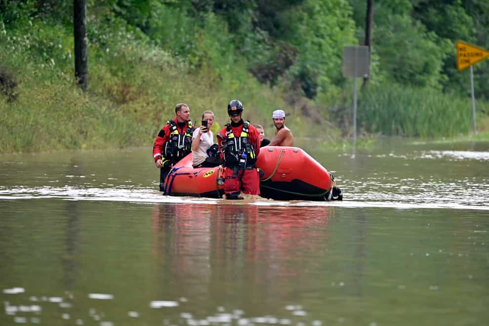 Rescue services pick up people stranded by the floodwaters (Timothy D. Easley/AP)