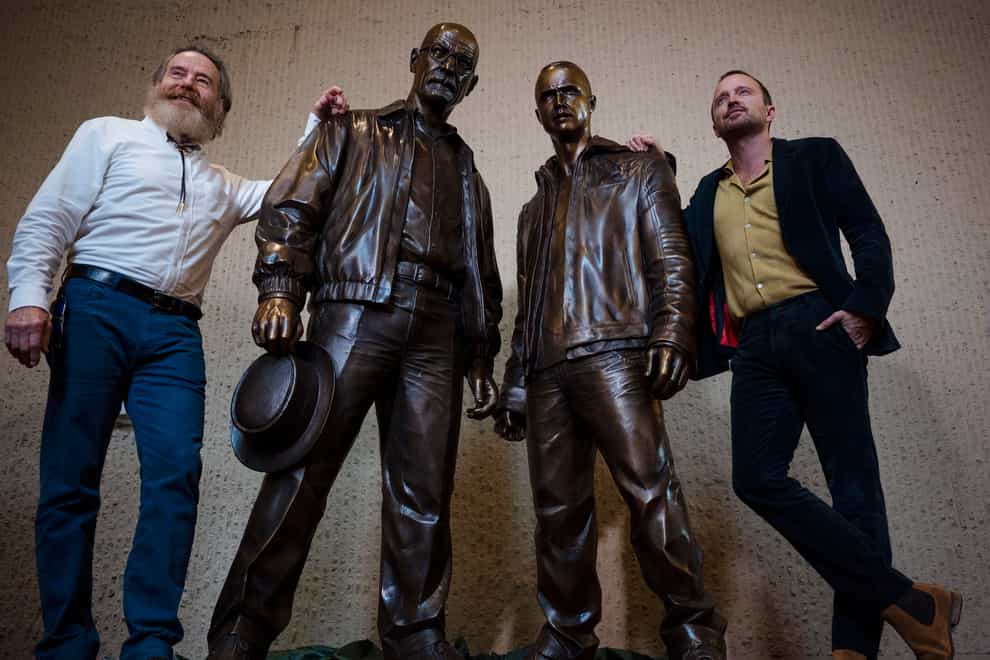 Bryan Cranston, left, and Aaron Paul, right, with the statues (Chancey Bush/The Albuquerque Journal via AP)