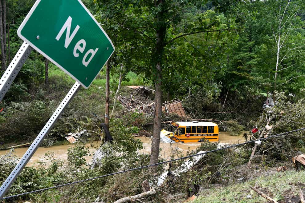 A school bus is destroyed after being caught up in the floodwaters (Timothy D. Easley/AP)