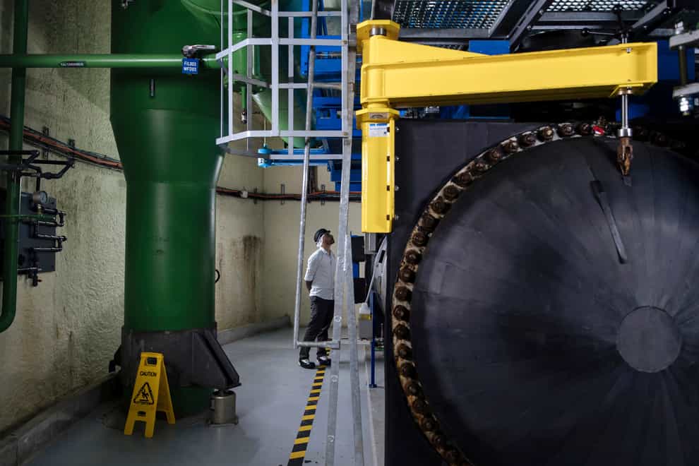 A worker inspects machinery in Paris’s underground cooling system (Lewis Joly/AP)